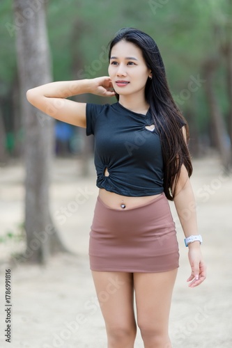Woman in Black Shirt and Brown Skirt Standing at the Beach in Summer