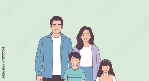 A smiling family of four, including parents and two children, posing together against a soft green background, conveying warmth and togetherness.