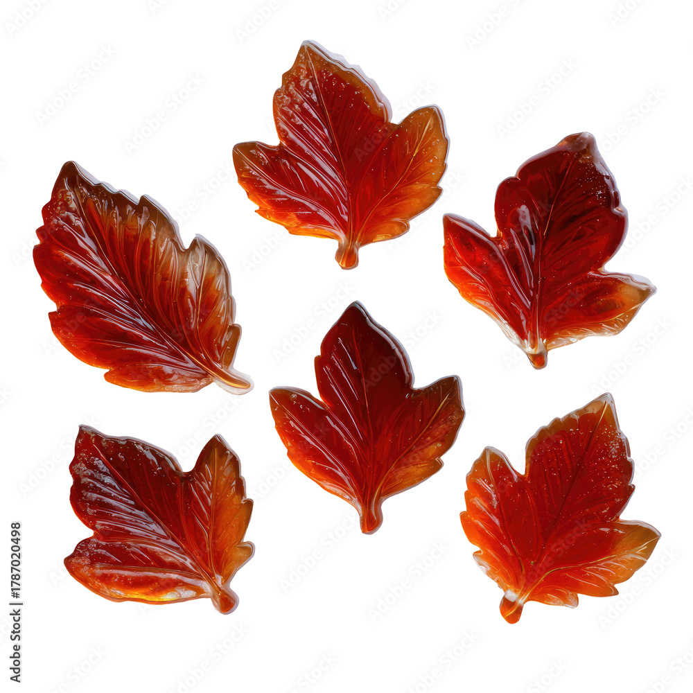 Obraz premium Red, translucent leaf candies scattered on a dark background