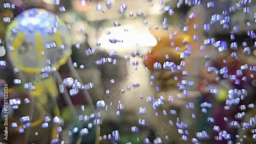 Bubbles are coming out of the generator in a small aquarium. Air bubbles in the aquarium come from the air pump and water filter. Air bubbles moving upwards in the water. The fish swimming in there.
