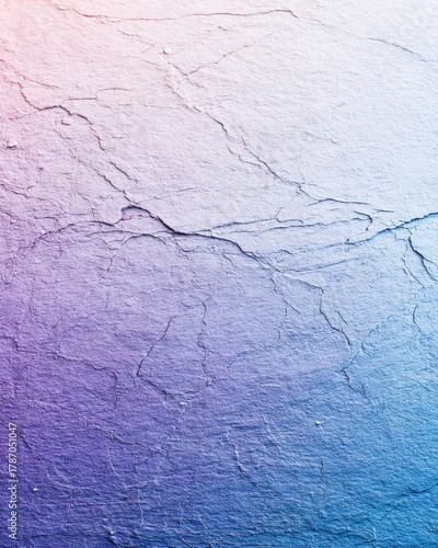 Textured surface with gradient of pink to blue, featuring visible cracks and lines, creates abstract and artistic effect. image evokes sense of depth and complexity