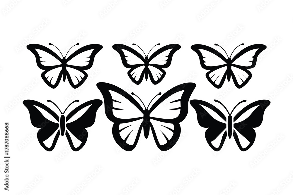 Fototapeta premium Several beautiful symmetrical butterflies are visible in striking black silhouette against a transparent background