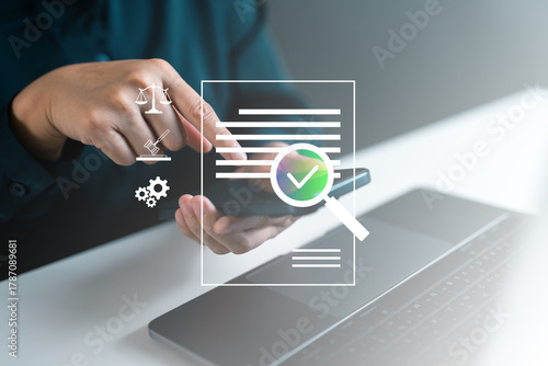 Businesswoman verifying document with smartphone. Business auditing, regulation management, digital compliance, legal approval and online document validation system in corporate technology concept.