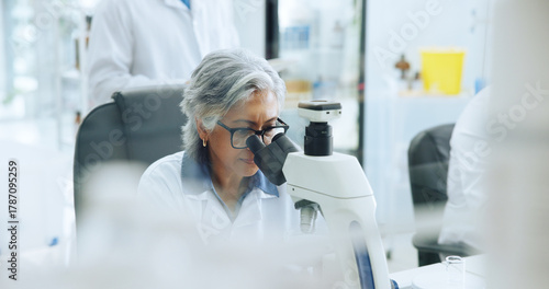 Microscope, medical research and woman in lab, genetics test and pharmaceutical study. Mature person, innovation and scientist with equipment, microbiology or vaccine development with bacteria
