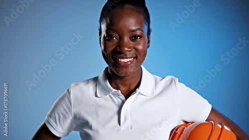 Confident African American Female Engineer Holding Hard Hat and Smiling.