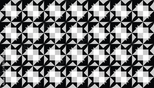 A bold monochrome pattern composed of sharp geometric fragments arranged in a repeating grid. The contrast between black, white, and gray forms produces a striking