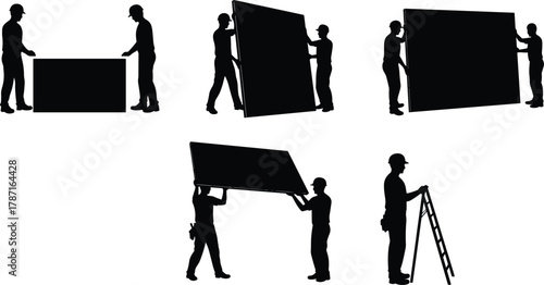 Construction workers installing large wall panels, teamwork lifting and fitting drywall sheets, building structure installation and renovation process at construction site