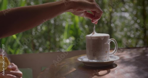 Woman stirring fancy hot chocolate drink at resturant - close up