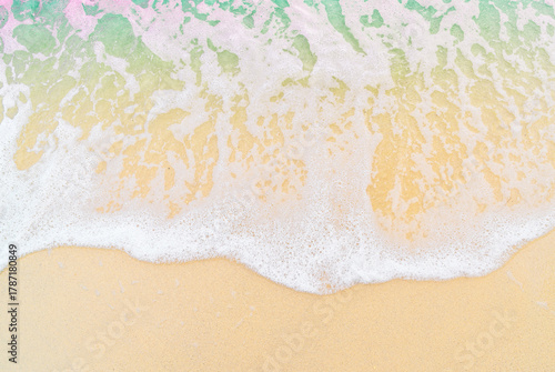 The image shows a close-up of sea foam rolling onto a sandy beach.
The clear dividing line between the foam and the dry sand creates a minimalist and abstract visual effect.