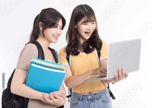 Excited Asian female students watching the laptop