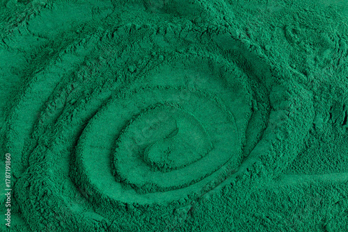 Beautiful abstract background of natural spirulina powder. Soft wavy lines of green color of natural algae powder. food additive. Detox.