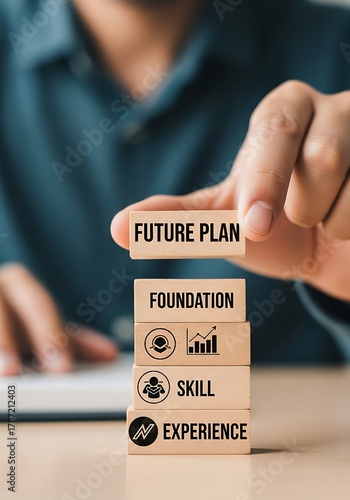 A close-up of a hand completing a career development strategy by placing the top wooden block