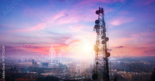 Telecommunication tower with cityscape background at sunset,panoramic view