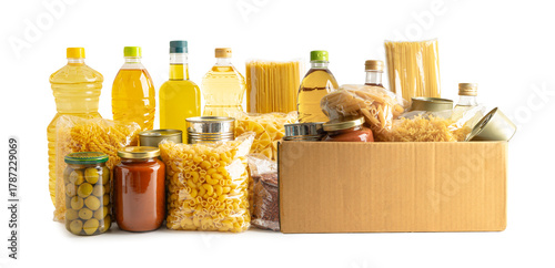 Foodstuff for donation, storage and delivery. Various food, pasta, cooking oil and canned food in cardboard box.