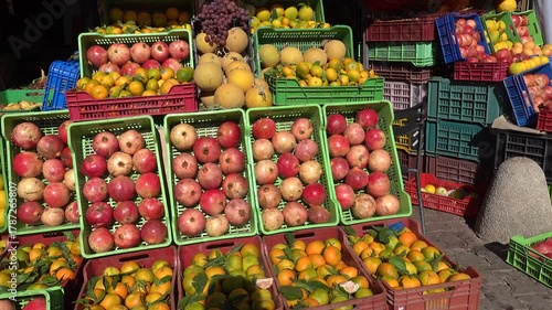 Tunis, Tunisia A display of fruit like oranges and pomegranates at an outdoor fruit stand. 