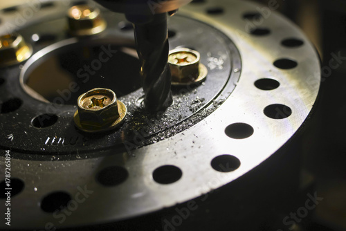 Wallpaper Mural Closeup of drill drilling metal screw during mechanical repair and maintenance in workshop. focus on precision work for vehicle brake disc service and customization Torontodigital.ca