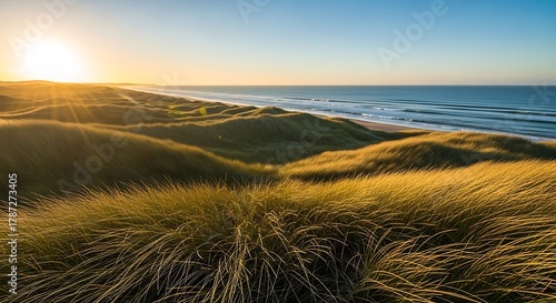 Golden Hour Sunrise Over Coastal Sand Dunes and Ocean Waves