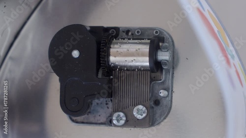 Intricate Device: Exposed Music Box Mechanism Plays Drawn-Out Melody