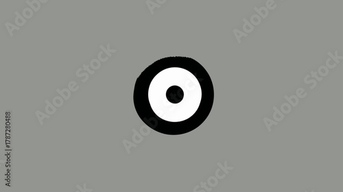 Abstract black and white target symbol on a grey background, simple focus point icon, minimalist graphic design element.