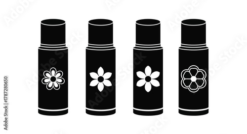 four black lip gloss tubes with floral designs on caps