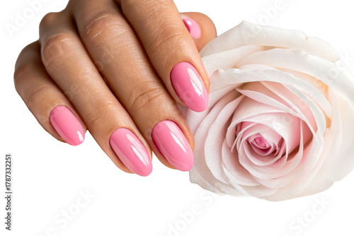 Close up of a woman's hand with pink nails beside a delicate rose