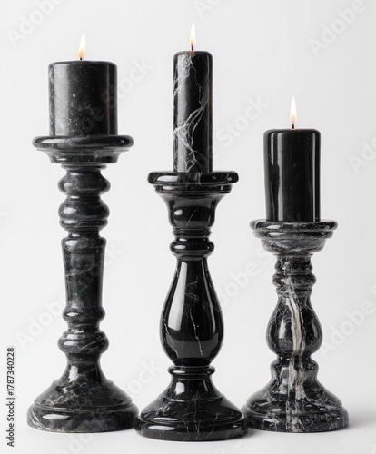 Black marble candlesticks with lit candles, minimalist luxury still life