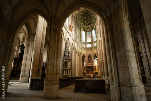 Kutná Hora, Czech Republic – August 8, 2025: Side aisle view of St. Barbara’s Cathedral with Gothic arches framing the ornate Baroque altar and chancel in Kutná Hora