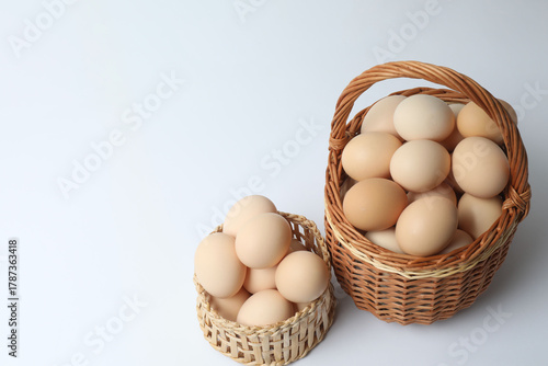 Wallpaper Mural Chicken eggs in a basket, isolated on a white background
 Torontodigital.ca