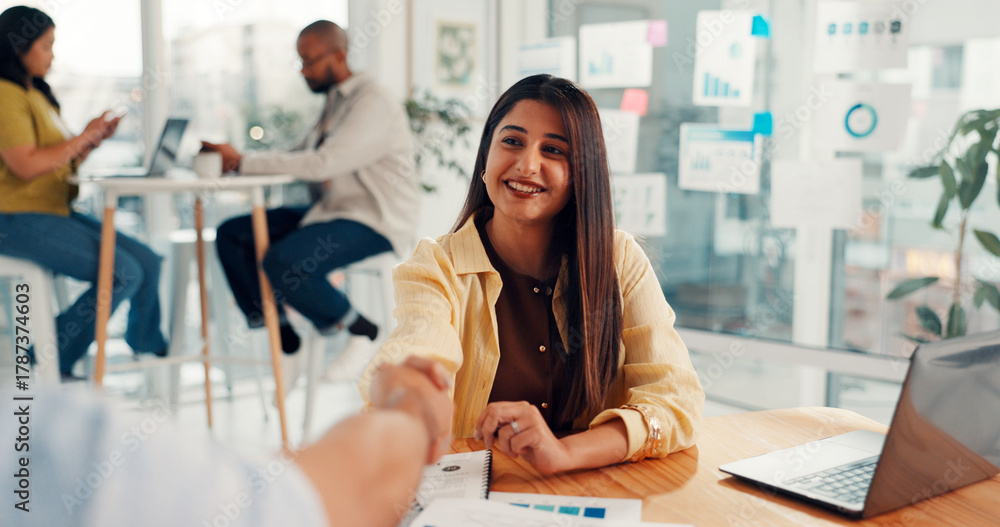 Obraz premium Handshake, agreement and businesswoman in office with greeting, deal or partnership in meeting. Happy, contract and female hr manager shaking hands with employee for performance review in workplace.