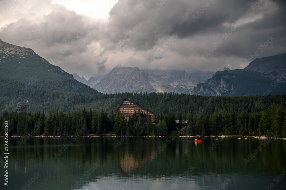 Fototapeta premium Serene Mountain Lake with Triangular Building