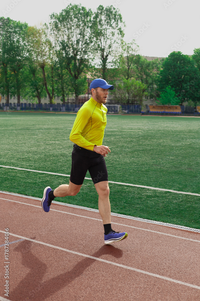 Fototapeta premium Man running at the city stadium