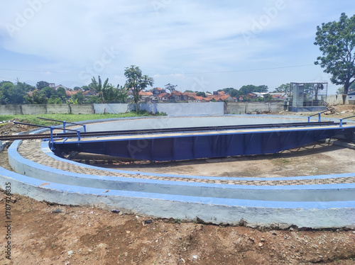 A blue railway turntable for locomotives at a locomotive depot. A locomotive turntable is a device used to turn trains so they can reverse direction. Infrastructure and technology at a train station
