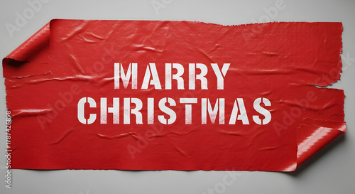 Wrinkled red paper displaying marry christmas in white stenciled letters