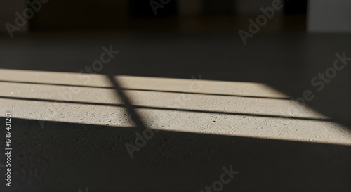 Geometric Window Light Pattern on Textured Concrete Floor with Sunbeams