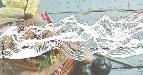 Obraz na plátně Displaying rustic spread with roasted bird, carrots, corn, tomatoes on blue plan