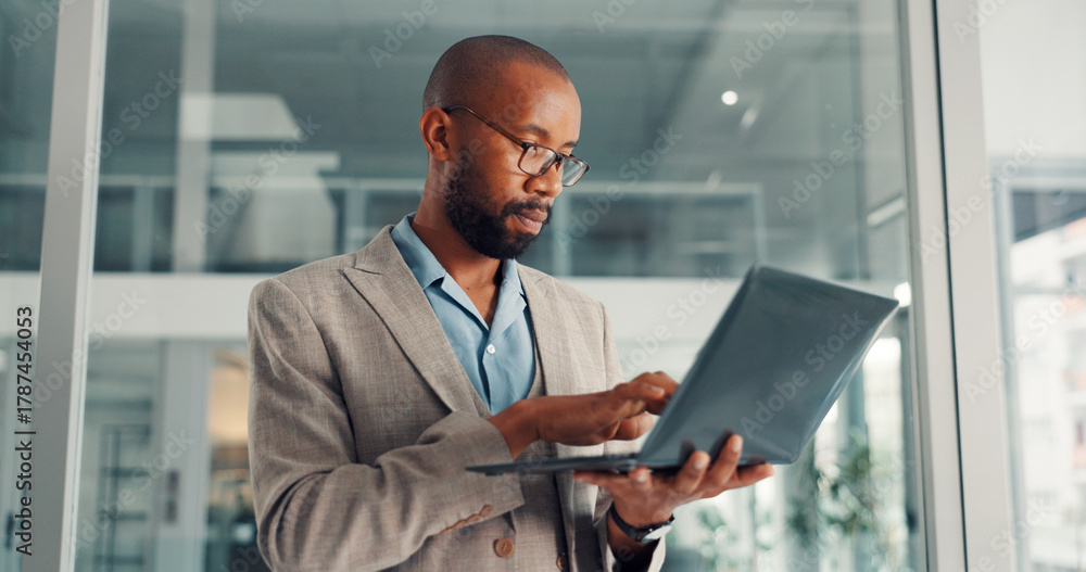 Fototapeta premium Online, research and businessman with laptop, office and financial analysis on web, typing and info. Investment banker, black person and plan for pitch with technology, wealth management or low angle