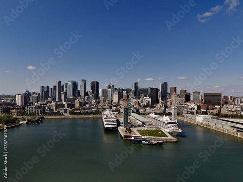 Aerial view of the Old Port, with its iconic clock tower and cruise ships, against a backdrop of modern skyscrapers, Montreal, Quebec, Canada.