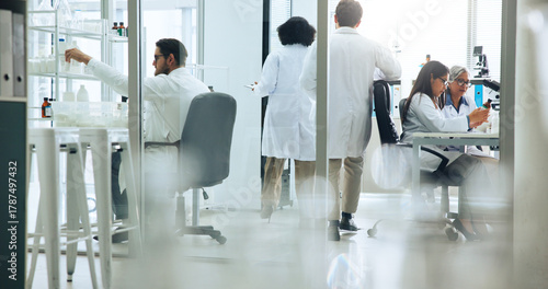 Busy, science and walking with people in laboratory together for medical or pharmaceutical research. Development, innovation and medicine with scientist team at work on clinical trial or experiment