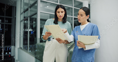 Team, documents and nurse or women in hospital for ward clerk, icu emergency and medical records at night. Healthcare administration, surgery schedule and discussion with people for overtime