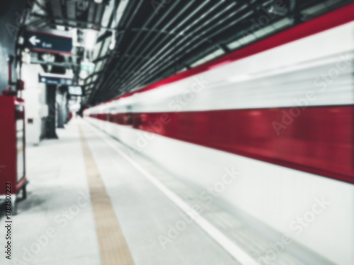 Abstract blurry The electric train with motion blur Forward on rail tracks in the station with blank passenger. Speed train concept.