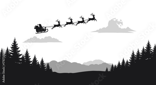 Silhouette of santa claus flying in his sleigh pulled by reindeer over a winter forest landscape at night