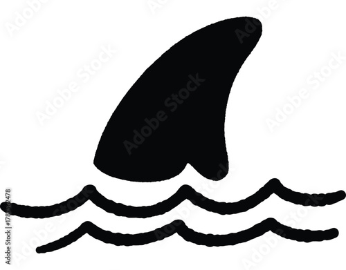 A black and white image of a shark's tail with water in the background. Concept of danger and power, as the shark's sharp tail is a symbol of its predatory nature