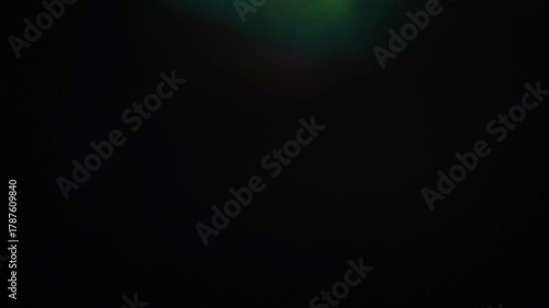 Sun glare, lens flare on a black background for transition to video. Colored rays	
