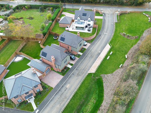 Aerial view of newly completed, detached executive homes and gardens seen on once brownfield site in rural Essex, UK. Note the newly laid lawns are Tudor designed homes.