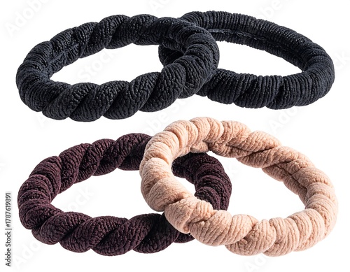 Four spiral hair ties, two black, one brown, and one tan, are arranged. They're on a white background, highlighting texture
