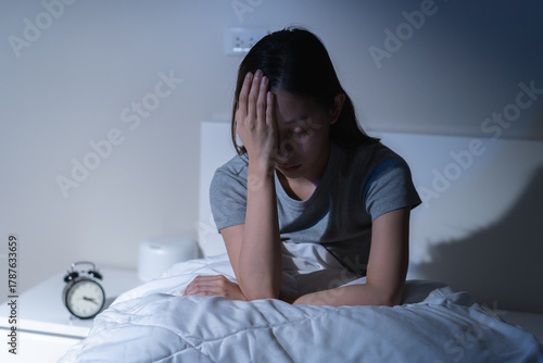 Tableau sur toile Sad worried and stressed, depressed asian young woman, girl suffering in bed from insomnia problem, awake at night, hand covering face from trouble disturbed loud noise, unable sleep