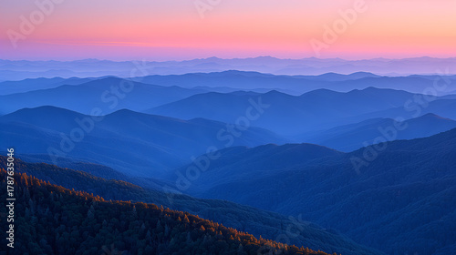Wallpaper Mural Tranquil Layered Mountain Ranges at Dawn with Soft Pink, Orange, and Blue Sky, Foreground Forested Ridge, Serene Horizon Torontodigital.ca