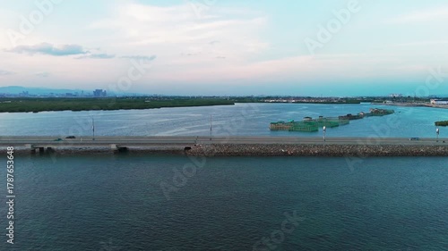 Wallpaper Mural 4K cinematic aerial drone shot of a coastal bridge at golden hour, leading toward the city skyline of Cebu, Philippines. A stunning scene symbolizing connection,progress, travel,and modern development Torontodigital.ca