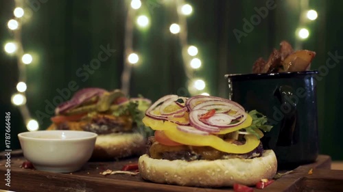 juicy burger on black plate, Juicy spicy beef burger rotating on table on black