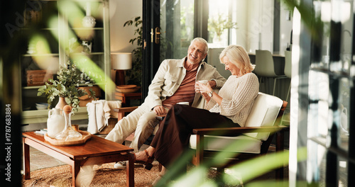 Coffee, laughing and relax with old couple in living room of home together for break or wellness. Drink, funny and love with happy senior people in apartment for bonding, me time or retirement